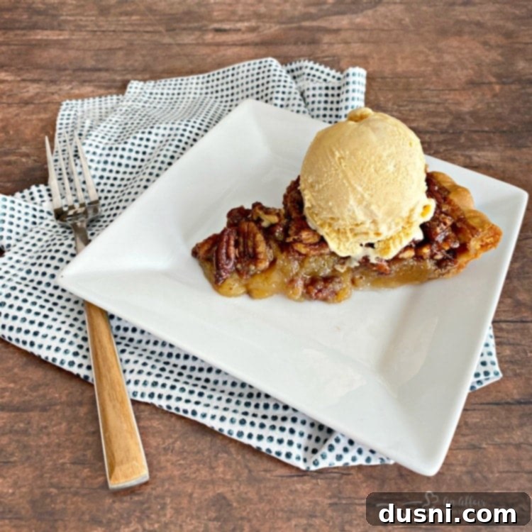 Pecan pie served with a scoop of pumpkin ice cream.