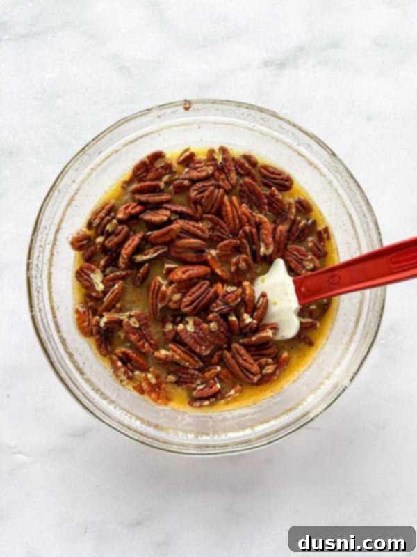 Pouring the browned butter into the sugar and egg mixture.
