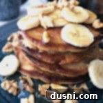 Banana Bread Bliss Stacks 11 Stack of Banana Bread Pancakes on a blue plate