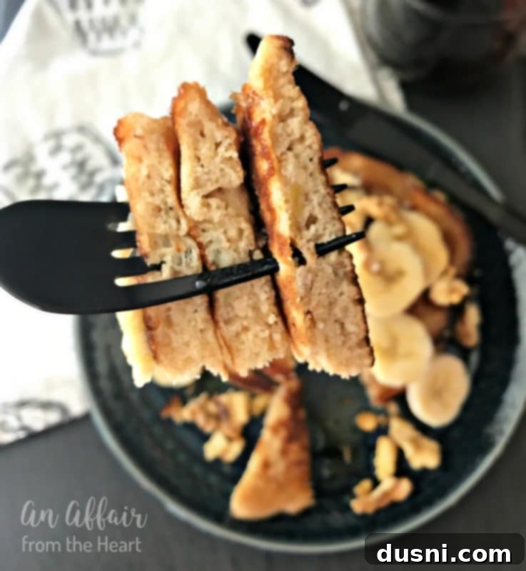 Banana Bread Bliss Stacks 5 Close-up of a single Banana Bread Pancake with a fork inserted, ready to eat.