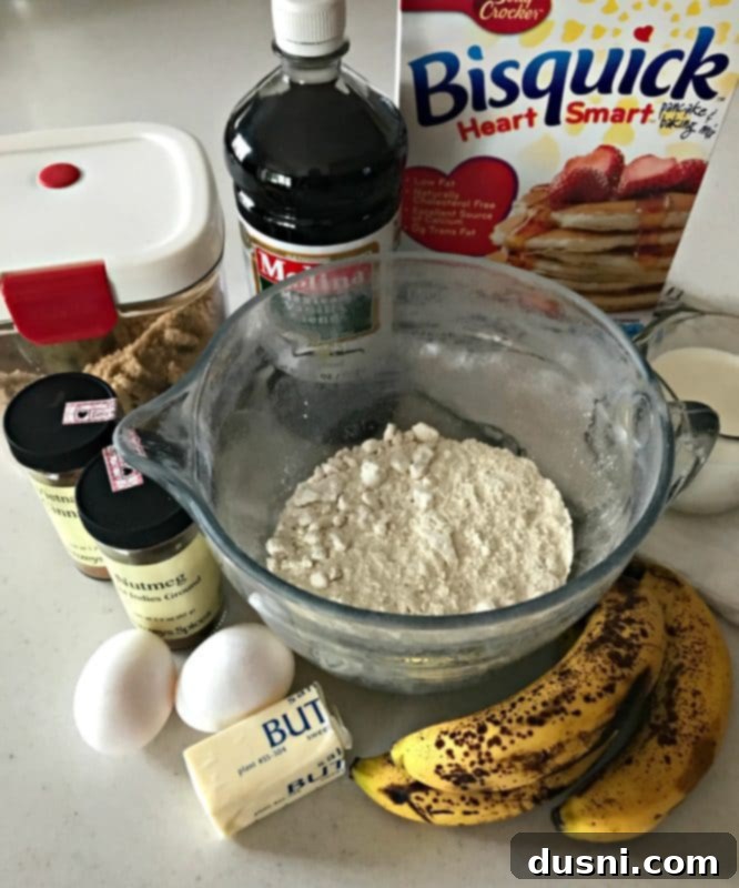 Banana Bread Bliss Stacks 6 Ingredients for Banana Bread Pancakes laid out: Bisquick mix, bananas, eggs, milk, brown sugar, butter, vanilla, cinnamon, nutmeg.