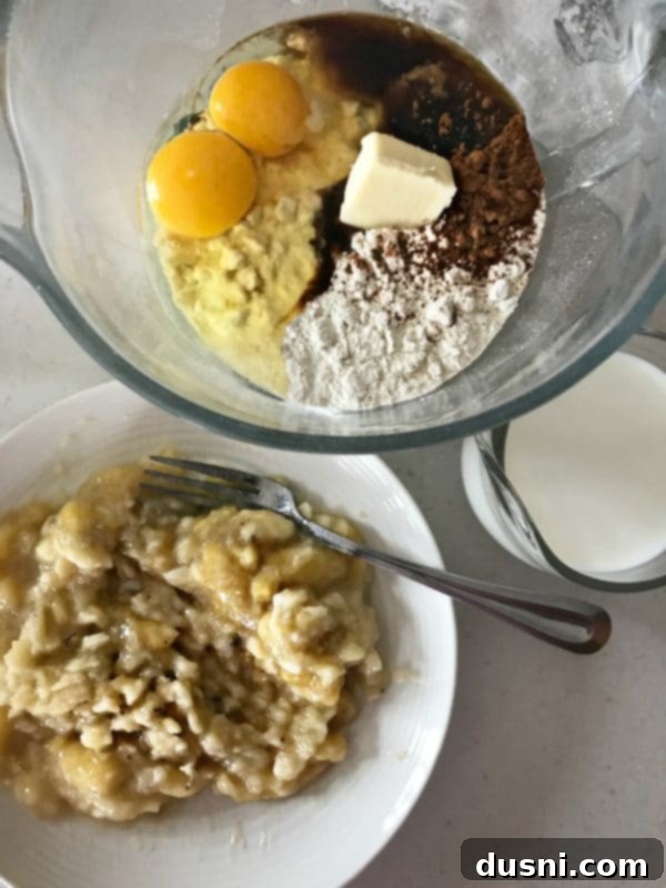 Banana Bread Bliss Stacks 7 Mixing bowl with mashed bananas, Bisquick, and other ingredients for pancake batter.