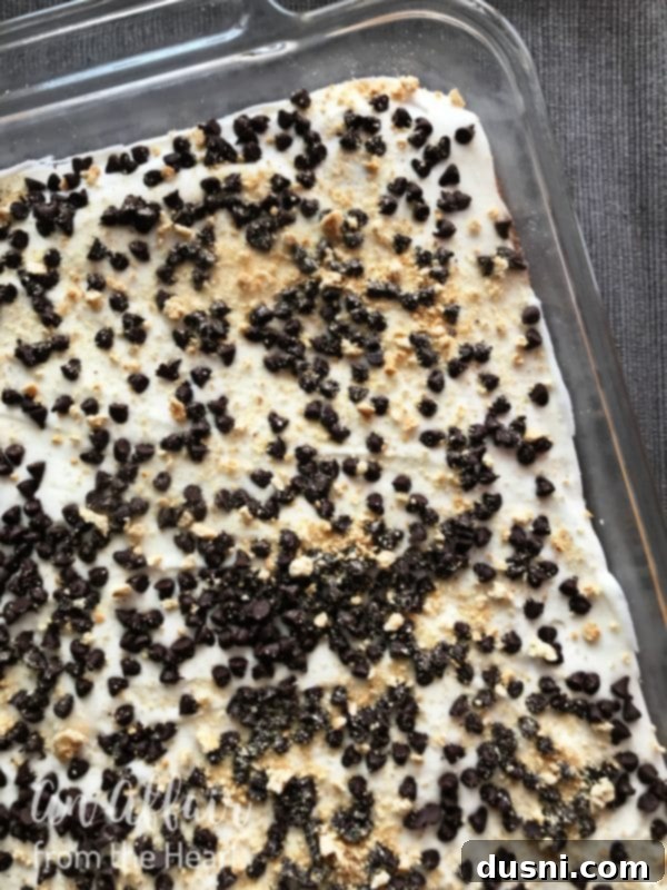 S'mores Brownies prep - frosting the cooled brownies