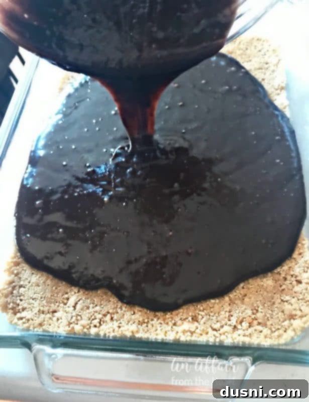 S'mores Brownies prep - pouring brownie batter over the crust