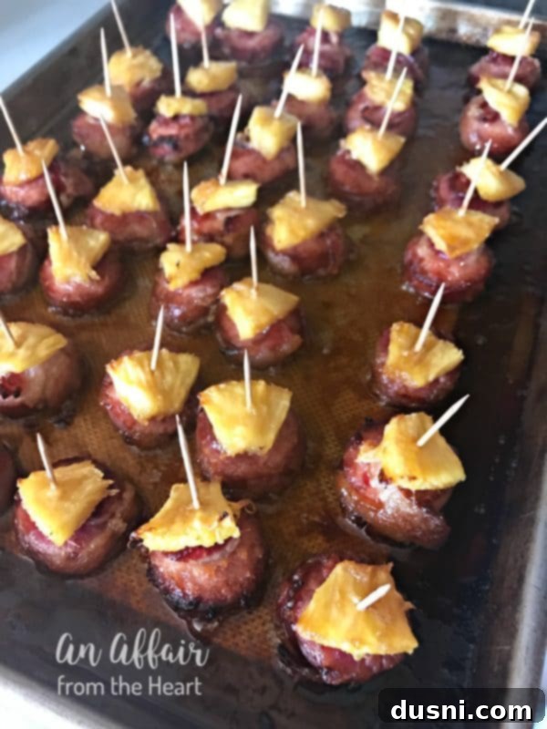 Aloha Bacon Wrapped Sausage Poppers 12 Baked Aloha Bacon Wrapped Sausage Bites on a baking sheet
