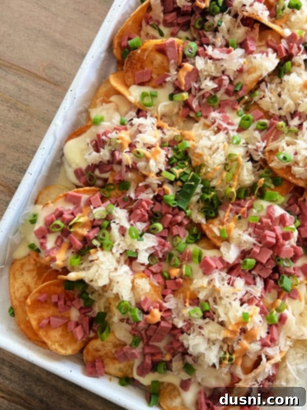 Loaded Reuben Nachos 11 Reuben Irish nachos on a sheet pan loaded with toppings and garnished