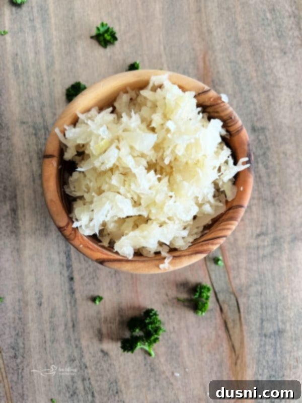 Loaded Reuben Nachos 16 A vibrant close-up of Reuben Nachos with a golden cheese sauce and fresh green garnish
