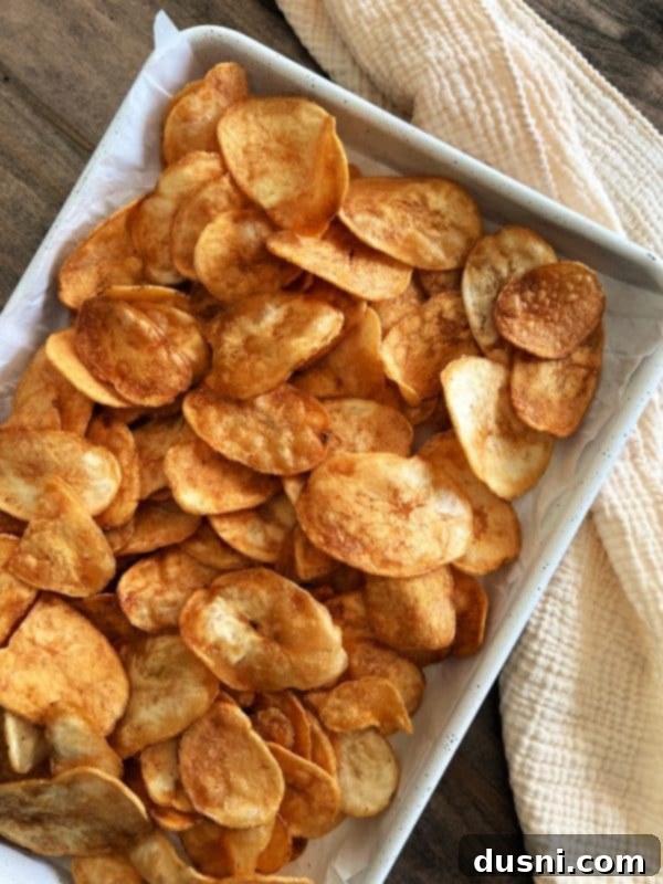 Loaded Reuben Nachos 6 A baking sheet lined with parchment paper, topped with a generous layer of thick-cut potato chips
