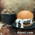 Monterey Jack-Smothered Green Chile Mushroom Burger 14 Green Chile Mushroom Burger with Monterey Jack Cheese Sauce on a blue plate