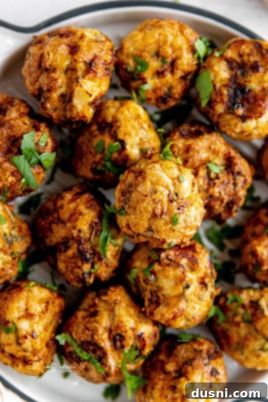 Crispy Air Fryer Turkey Meatballs 6 Raw meatballs on a cutting board.
