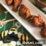 Sticky Sriracha Honey Glazed Wings 17 Close up of Honey Sriracha Wings on a white plate