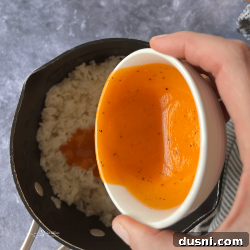 Dorothy's Golden Cheesy Vegetable Rice Bake 9 Adding Dorothy Lynch dressing to cooked rice.