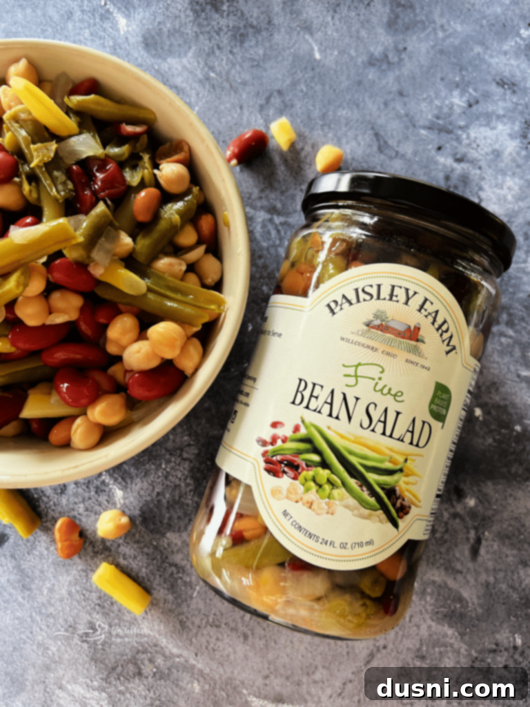 Five Bean and Cheese Enchiladas served on a plate with fresh toppings