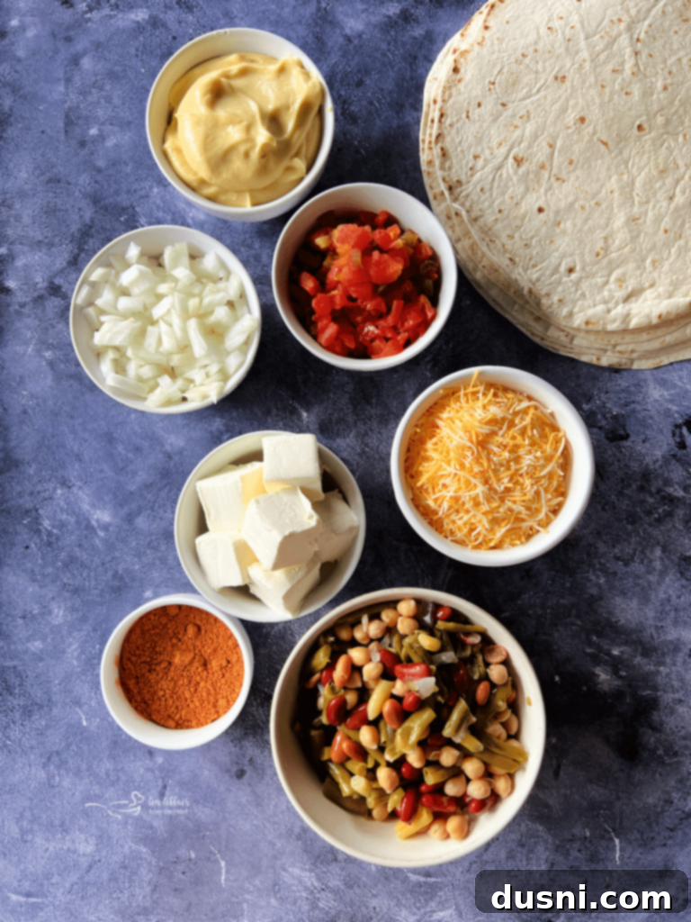 Overhead view of a tray of Five Bean and Cheese Enchiladas, garnished with cilantro