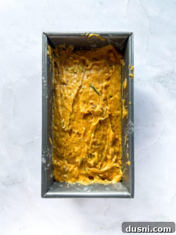 Pumpkin Patch Zucchini Crumble Loaf 11 Zucchini being stirred into the bread batter.