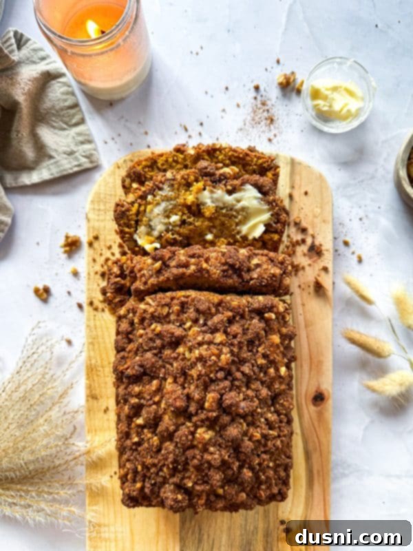 Pumpkin Patch Zucchini Crumble Loaf 17 A close-up of a loaf of Pumpkin Zucchini Streusel Bread, highlighting the moist interior.