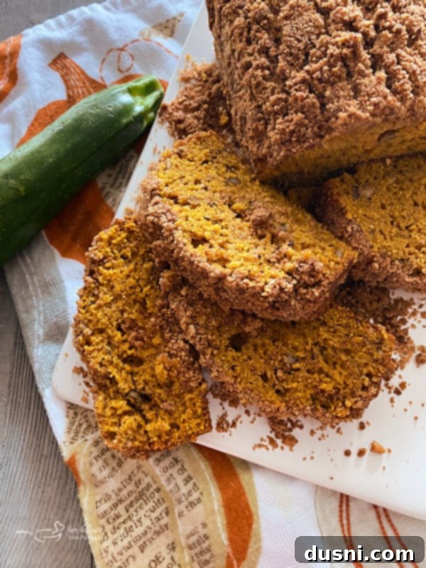 Pumpkin Patch Zucchini Crumble Loaf 18 A whole loaf of Pumpkin Zucchini Bread, ready to be sliced.