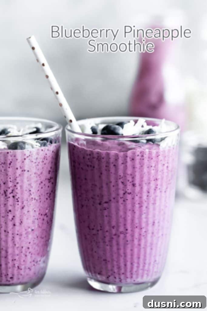 Vibrant Blueberry Pineapple Refresher 11 A beautifully presented Blueberry Pineapple Smoothie in a glass, ready to be enjoyed.