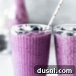 Vibrant Blueberry Pineapple Refresher 13 Close up of Blueberry pineapple smoothie with a straw in it