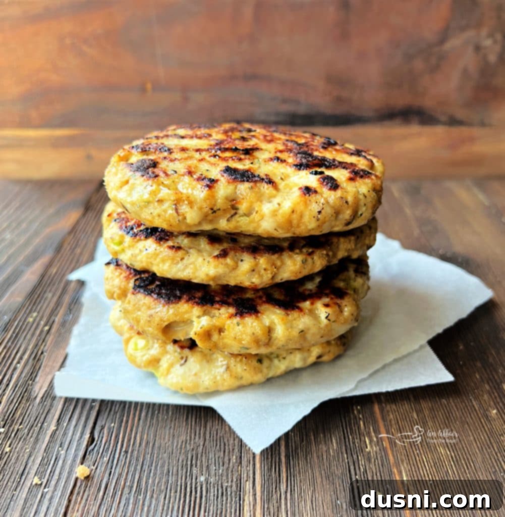 Close-up of a juicy turkey burger patty cooking on a skillet.