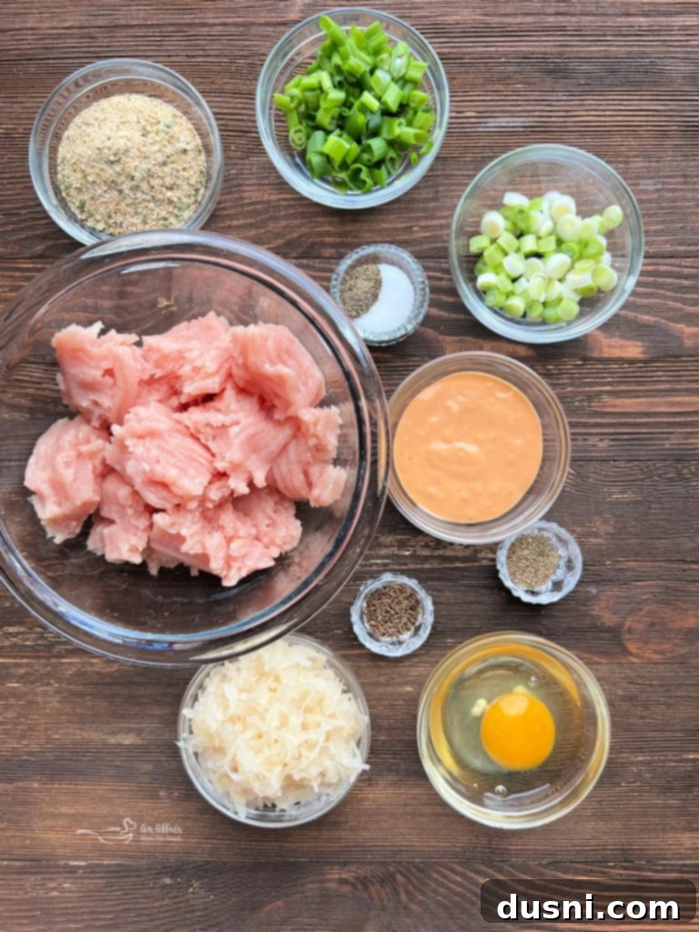 A close-up shot of two perfectly grilled Turkey Reuben Burgers.