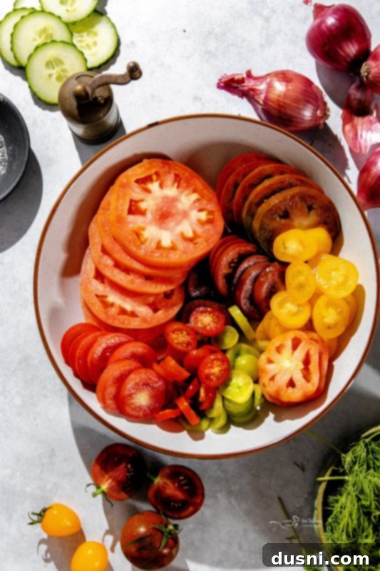 Refreshing Cucumber Tomato Salad 6 A close-up view of fresh tomatoes and cucumbers, prepped for salad.