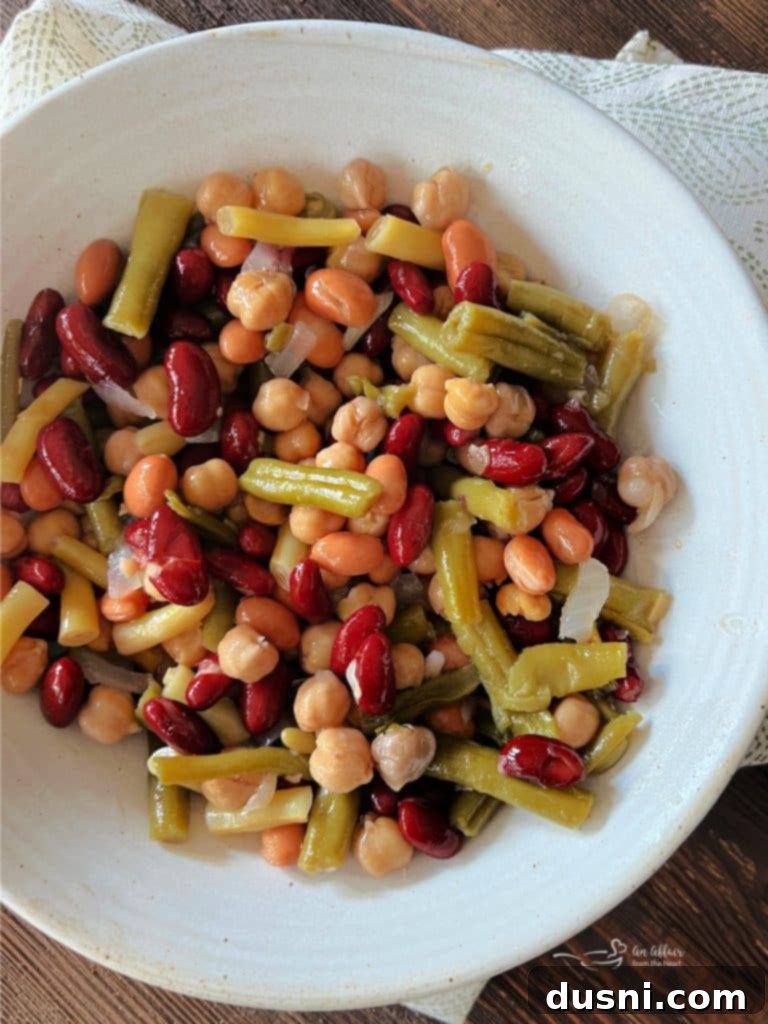 Two pieces of sweet and smoky grilled chicken on a white plate with corn.