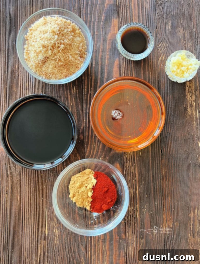Close-up of sweet and smoky grilled chicken breasts on a wooden cutting board.