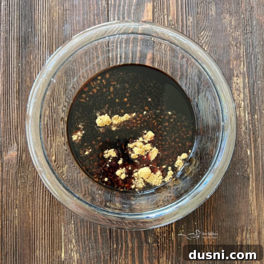 Whisking marinade ingredients in a bowl.