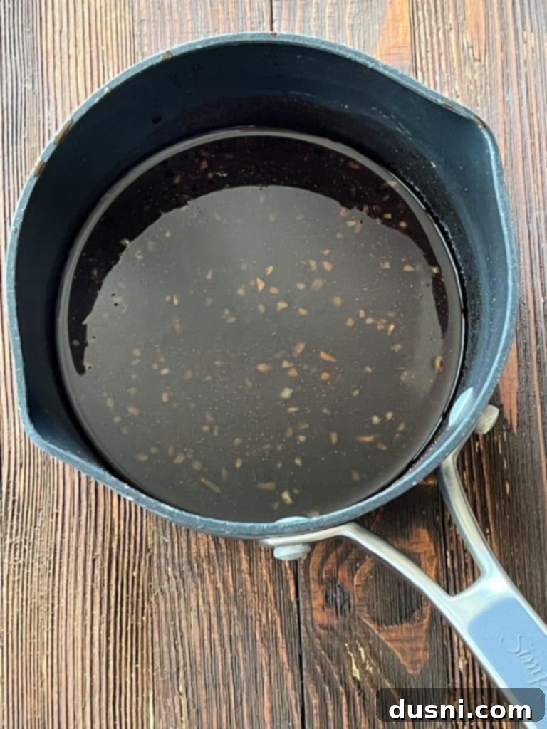 Marinade bubbling in a small saucepan on the stove.