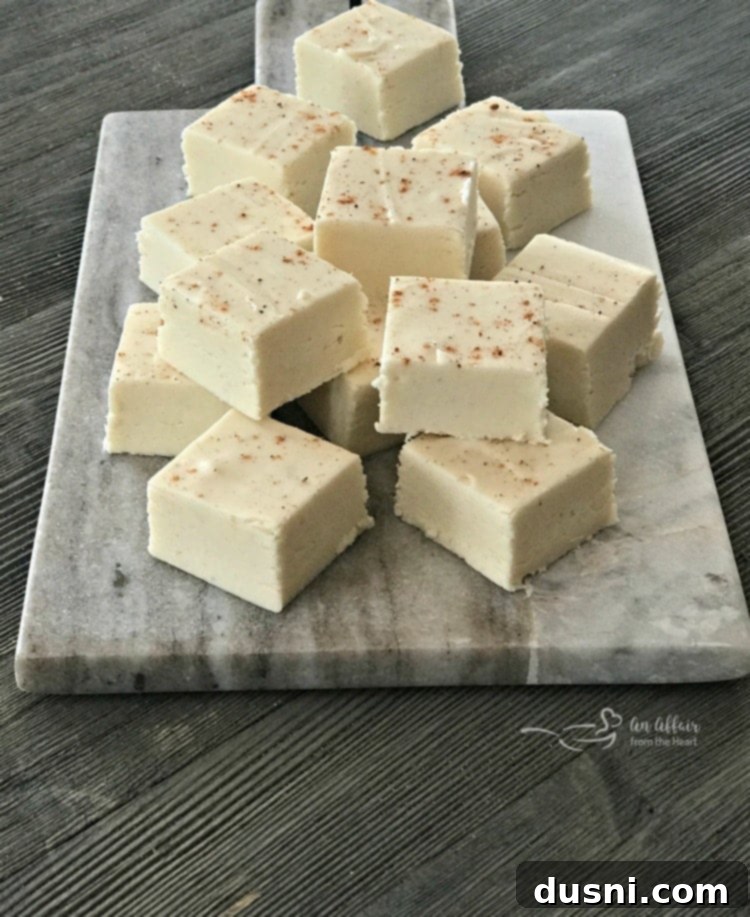 Yuletide Eggnog Bliss 7 Eggnog fudge squares neatly cut and arranged on a serving plate, ready for holiday festivities.