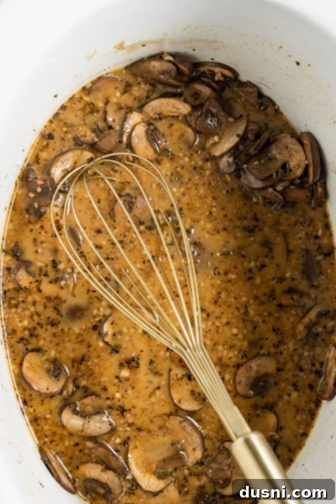Effortless Slow Cooker Chicken Marsala 10 Adding cornstarch slurry and heavy cream to Marsala sauce