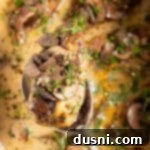 Extreme close up of Marsala chicken on a spoon