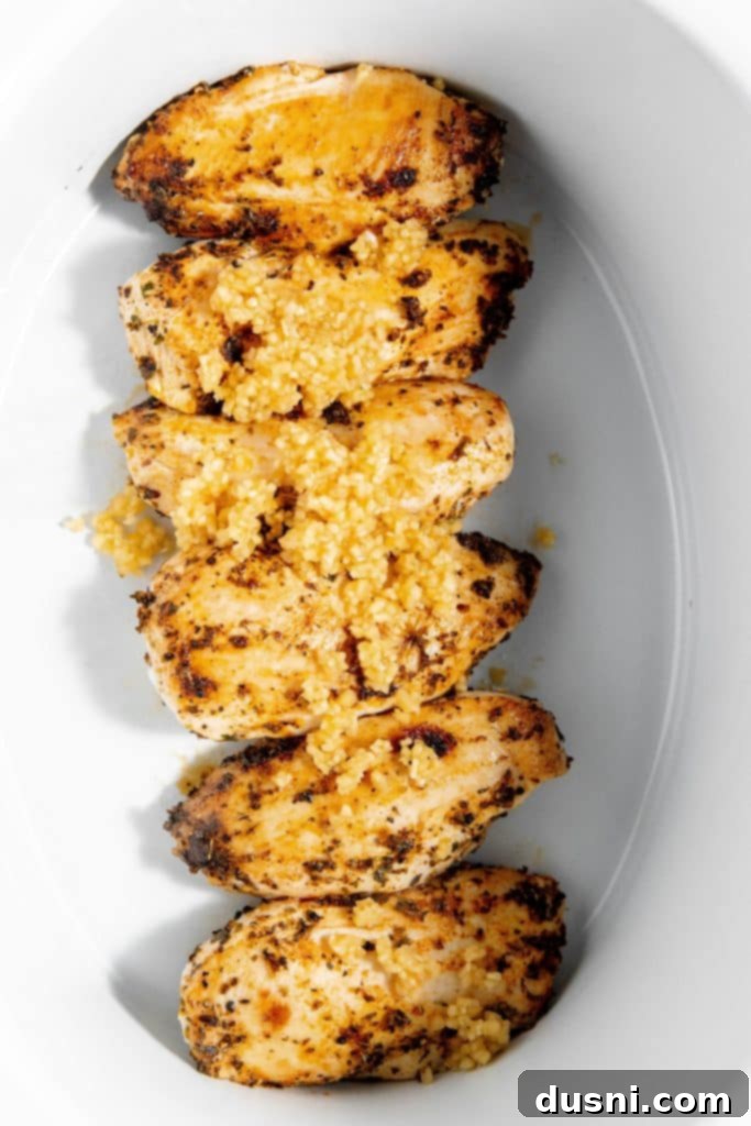 Effortless Slow Cooker Chicken Marsala 7 Seared chicken being transferred to a slow cooker