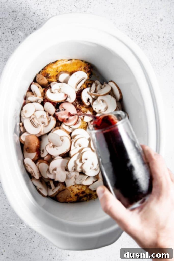 Effortless Slow Cooker Chicken Marsala 8 Mushrooms, garlic, and Marsala wine added to slow cooker