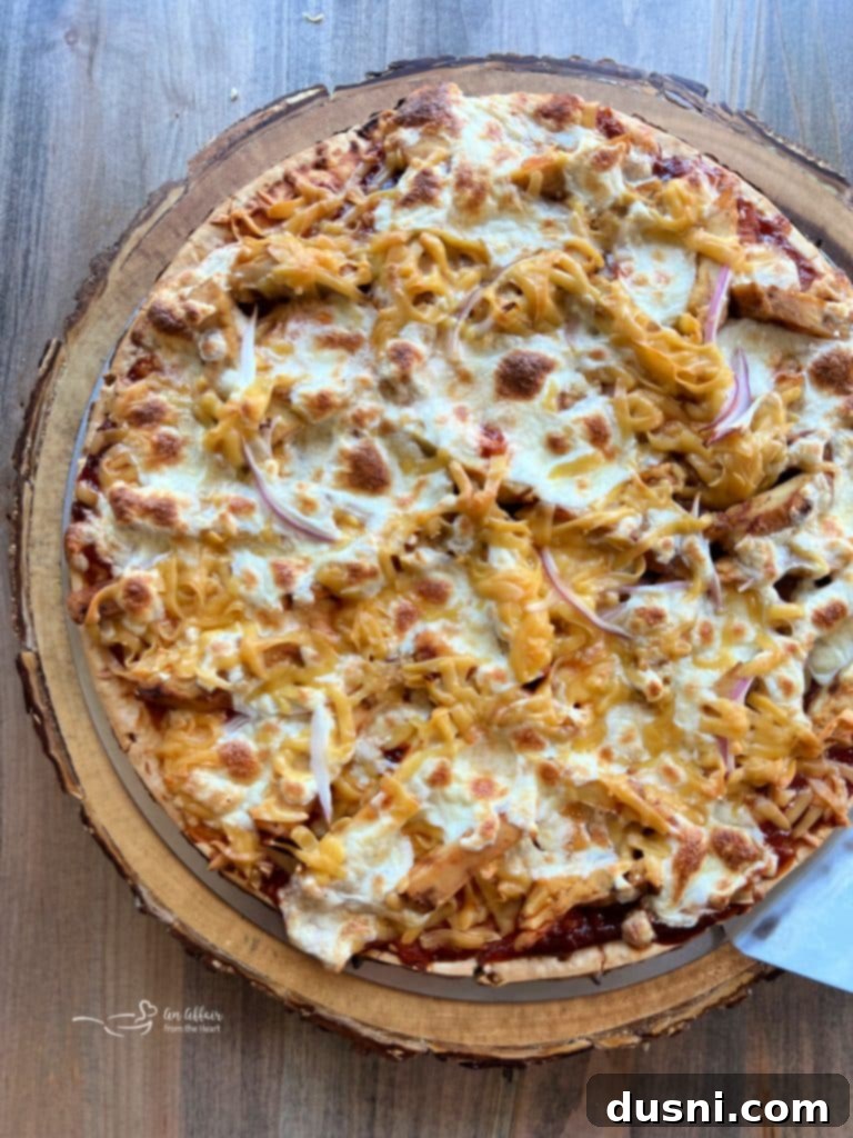 Delicious grilled BBQ chicken pizza with kraut, sliced and ready to serve.