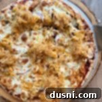 Freshly grilled BBQ Chicken Pizza with Kraut, before slicing.