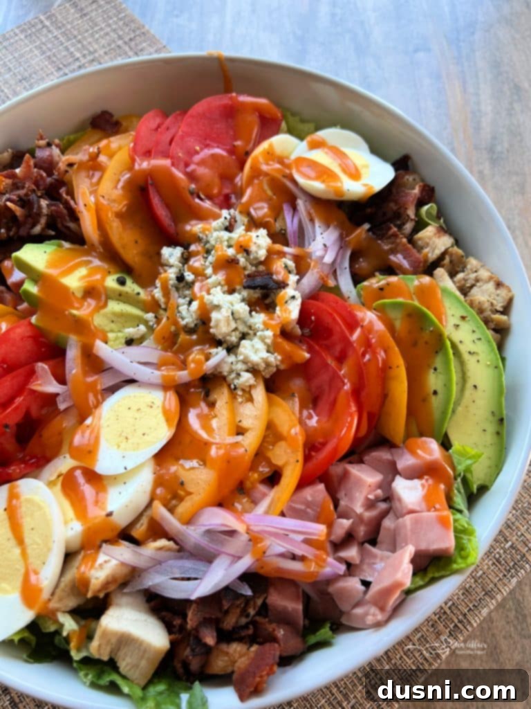 Summer's Crisp Cobb 6 The vibrant ingredients of Summertime Cobb Salad, including fresh romaine, bacon, chicken, and avocado.