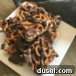 Sweet Salty Chocolate Pretzel Delight 18 Salted Caramel Chocolate Pretzel Bars stacked on a white plate