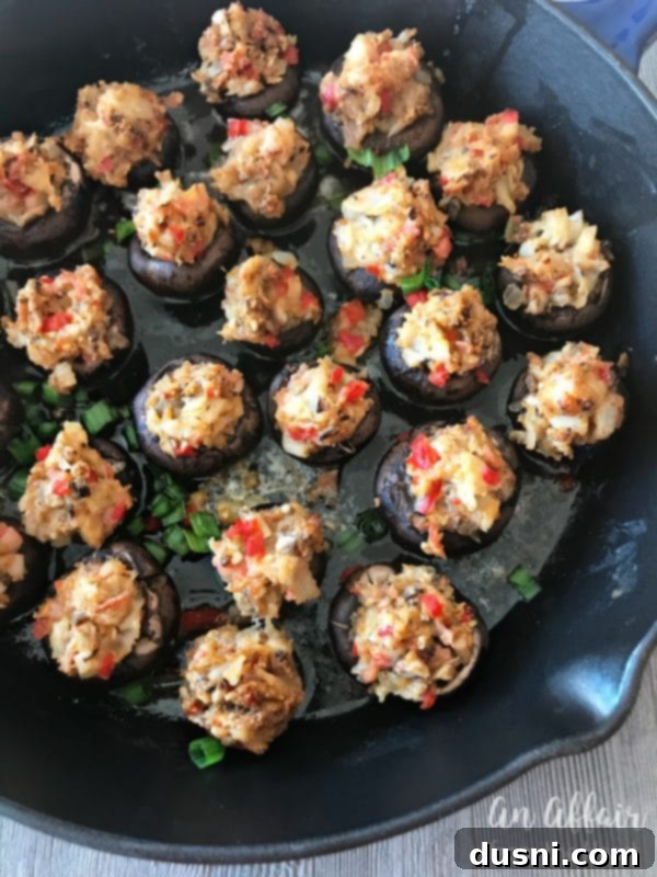 Creamy Surimi Stuffed Mushrooms 4 Close-up of baked Surimi Seafood Stuffed Mushrooms in a cast iron skillet