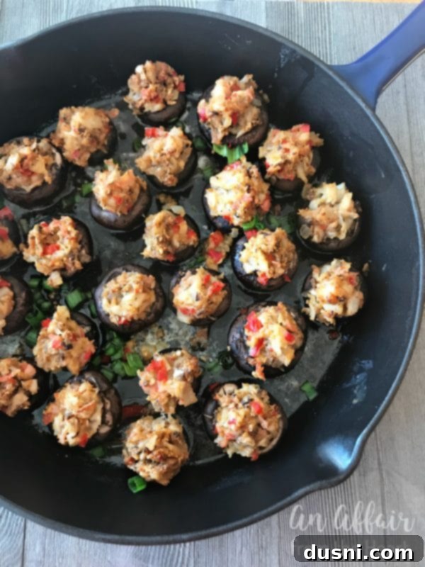 Creamy Surimi Stuffed Mushrooms 9 Stuffed mushrooms baking in a cast iron skillet