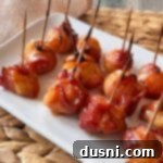 Dorothy's BBQ Bacon wrapped Water Chestnuts on a white serving platter.