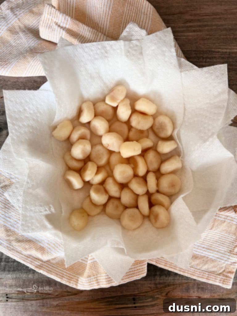 Canned whole water chestnuts, drained and ready for preparation.