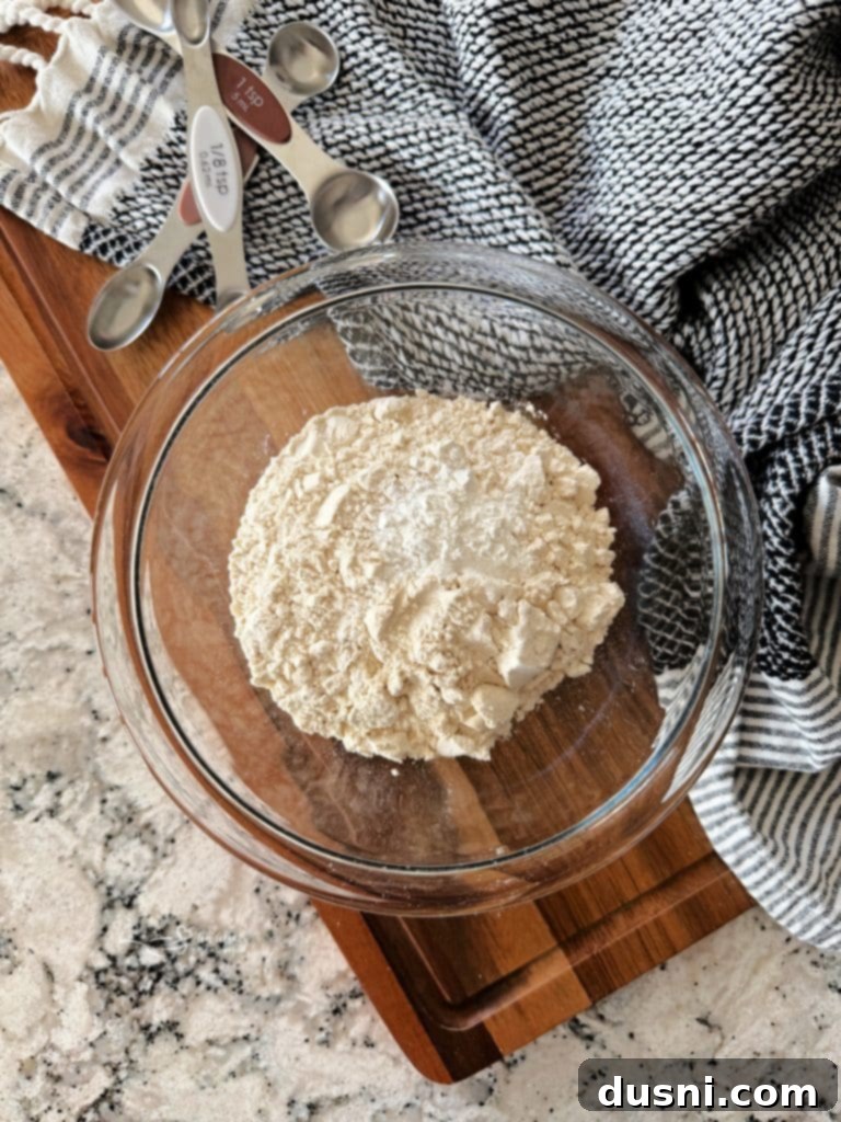 All the simple ingredients for self-rising flour laid out on a counter: all-purpose flour, baking powder, and salt.