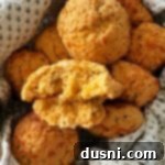 Dorothys Golden Cornbread Drops 14 Close up of a Dorothy's cornbread drop biscuit with a bite out of it.