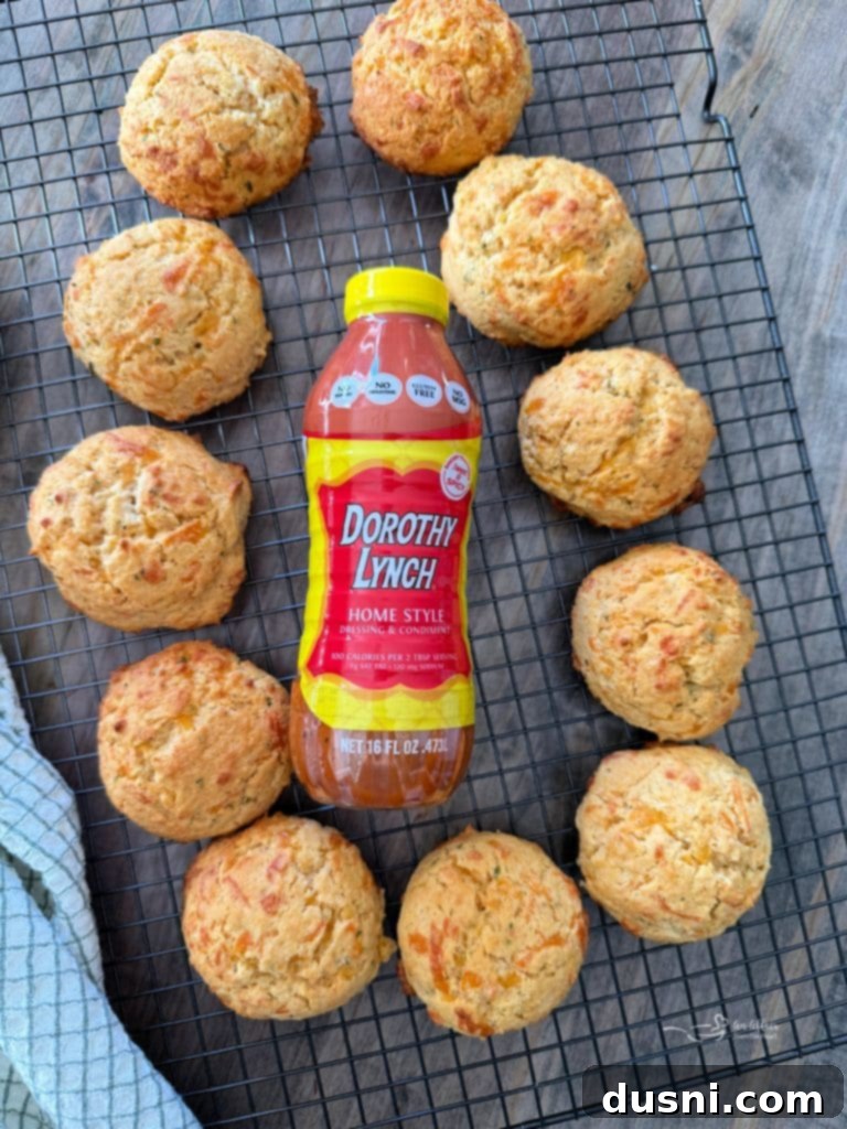 Dorothys Golden Cornbread Drops 4 Various ingredients for the cornbread drop biscuits laid out on a countertop, including a box of cornbread mix, cheddar cheese, and a bottle of Dorothy Lynch dressing.