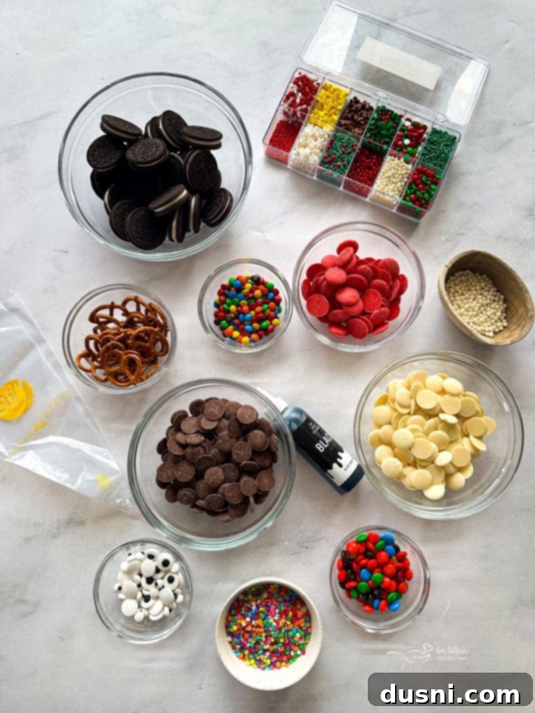 A collection of Christmas-themed chocolate-dipped Oreos, including reindeer, Santa suits, and polar bears, displayed on a wooden board.
