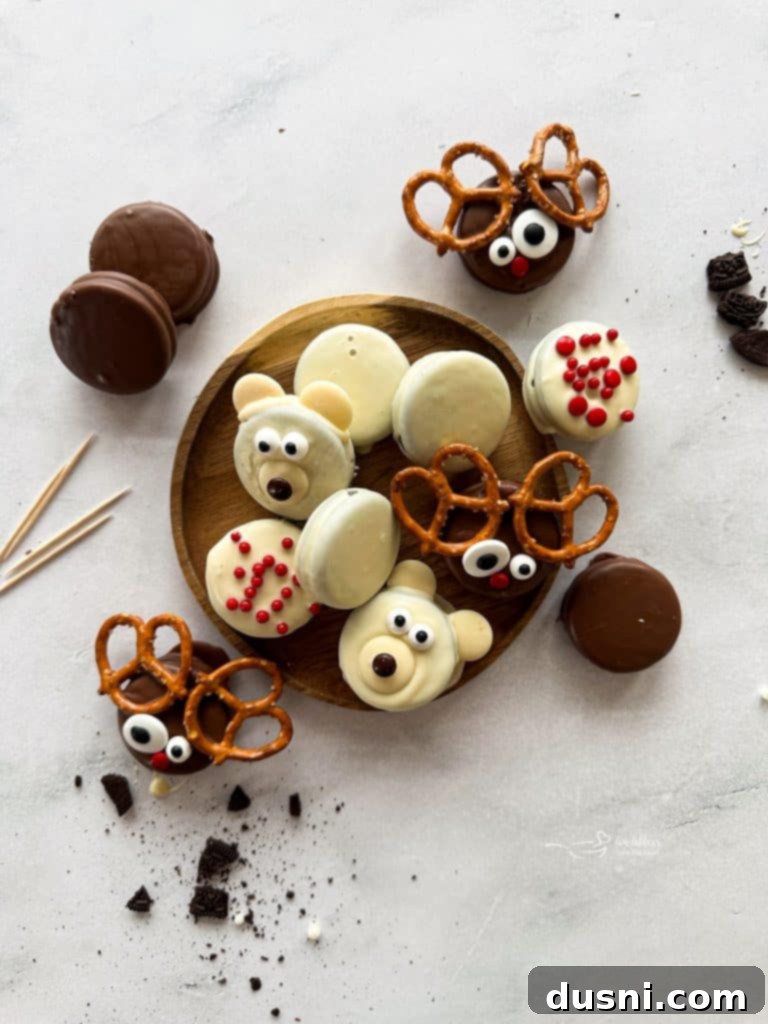 Close-up of a chocolate-dipped Oreo being decorated with candy eyes and a red M&M nose to create a reindeer.