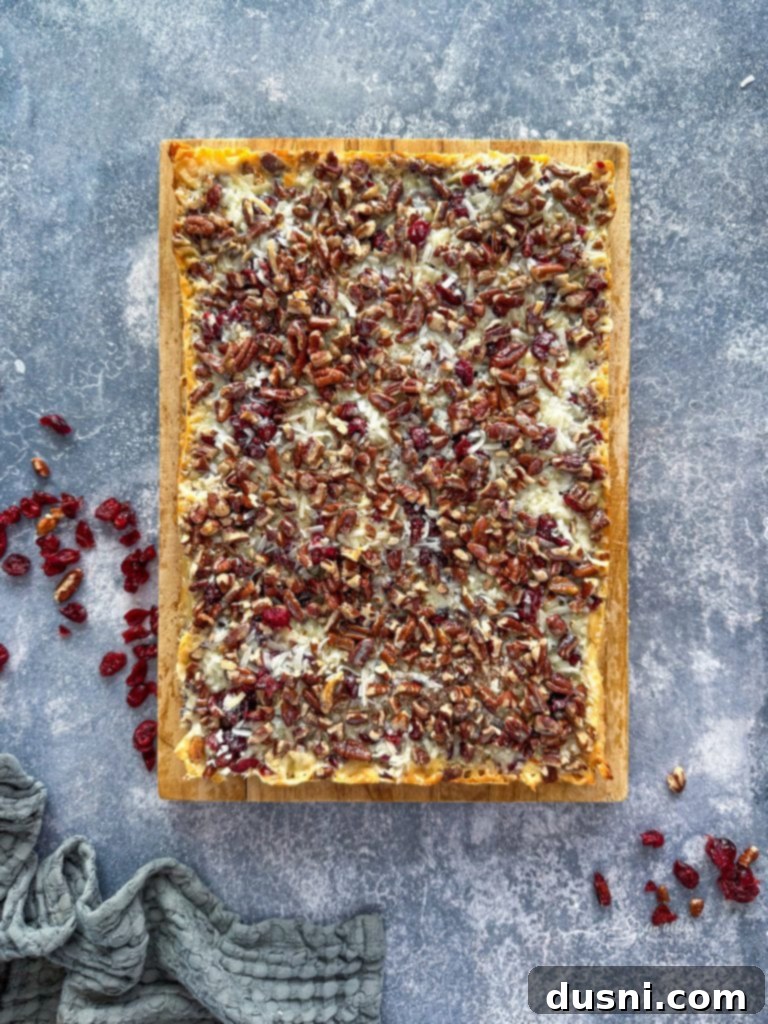 Crimson & Cacao Dream Bars 3 Stack of Double Chocolate Cranberry Magic Bars with a festive backdrop, perfect for holiday gatherings.
