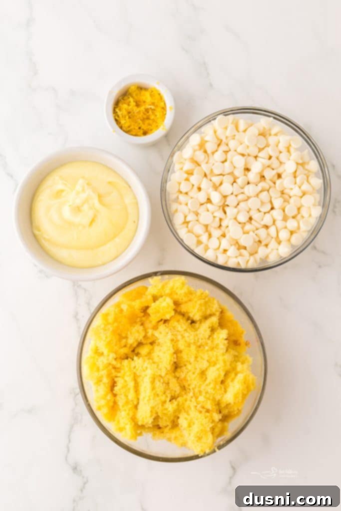 A plate of golden easy 4-ingredient lemon truffles, some drizzled with white chocolate.
